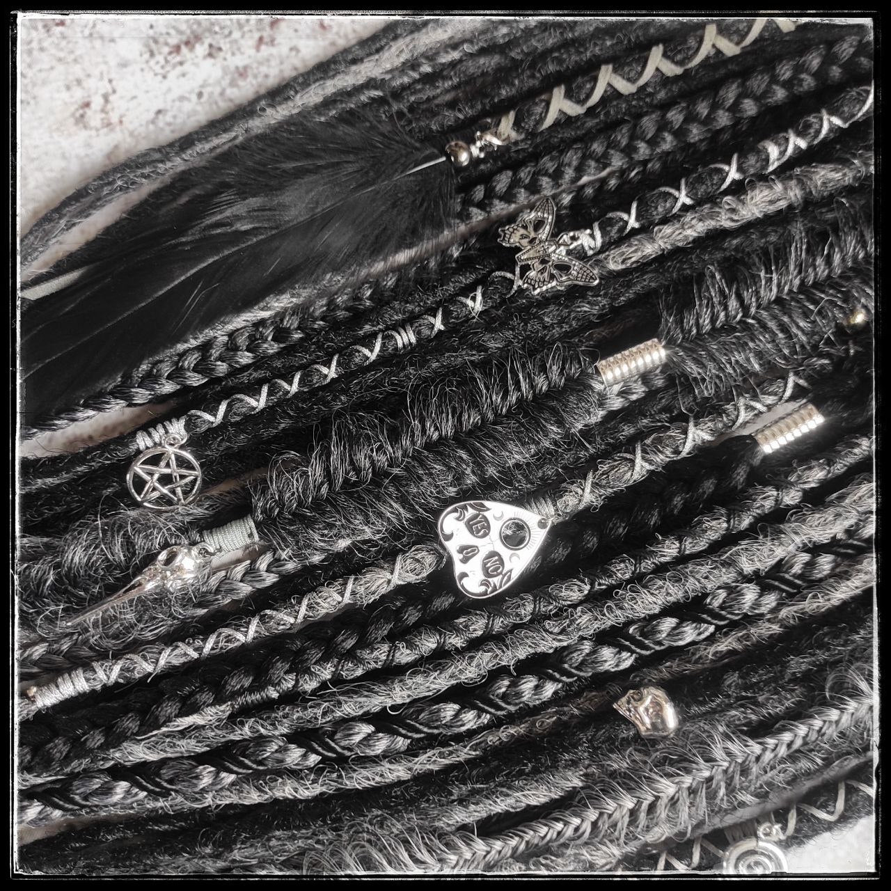 black and dark grey synthetic dreads with braids and goth jewelry
