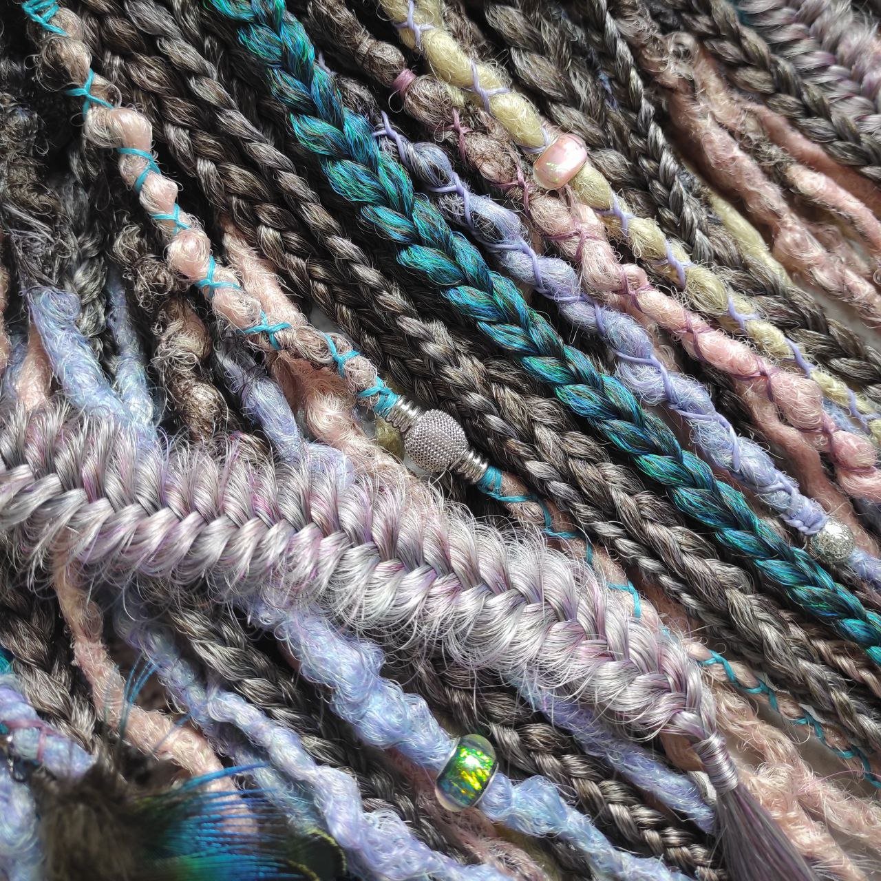 Pastel synthetic dreads with turquoise and brown-to-pink ombre extensions, including purple accents.