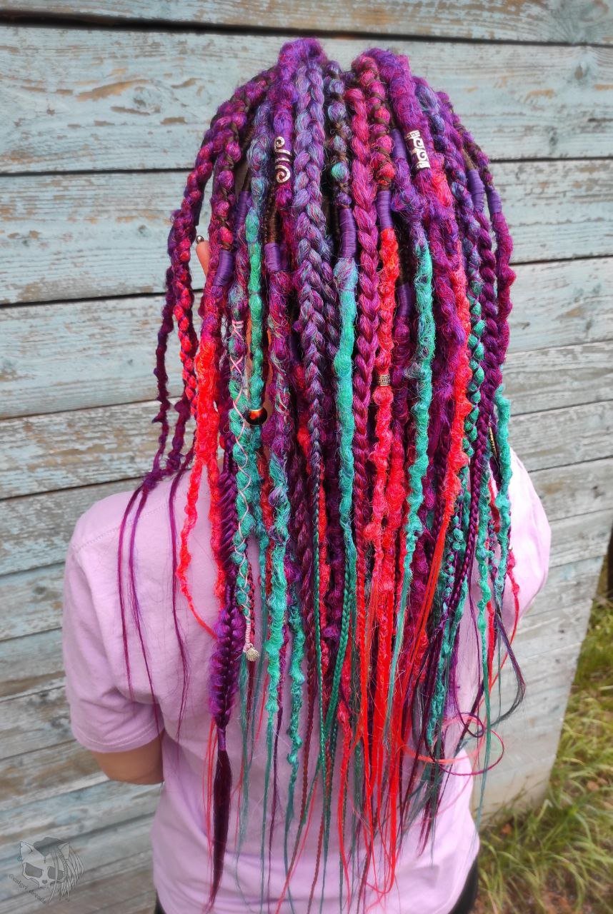 Synthetic dreads with braids featuring a striking ombre effect transitioning from purple to green and orange