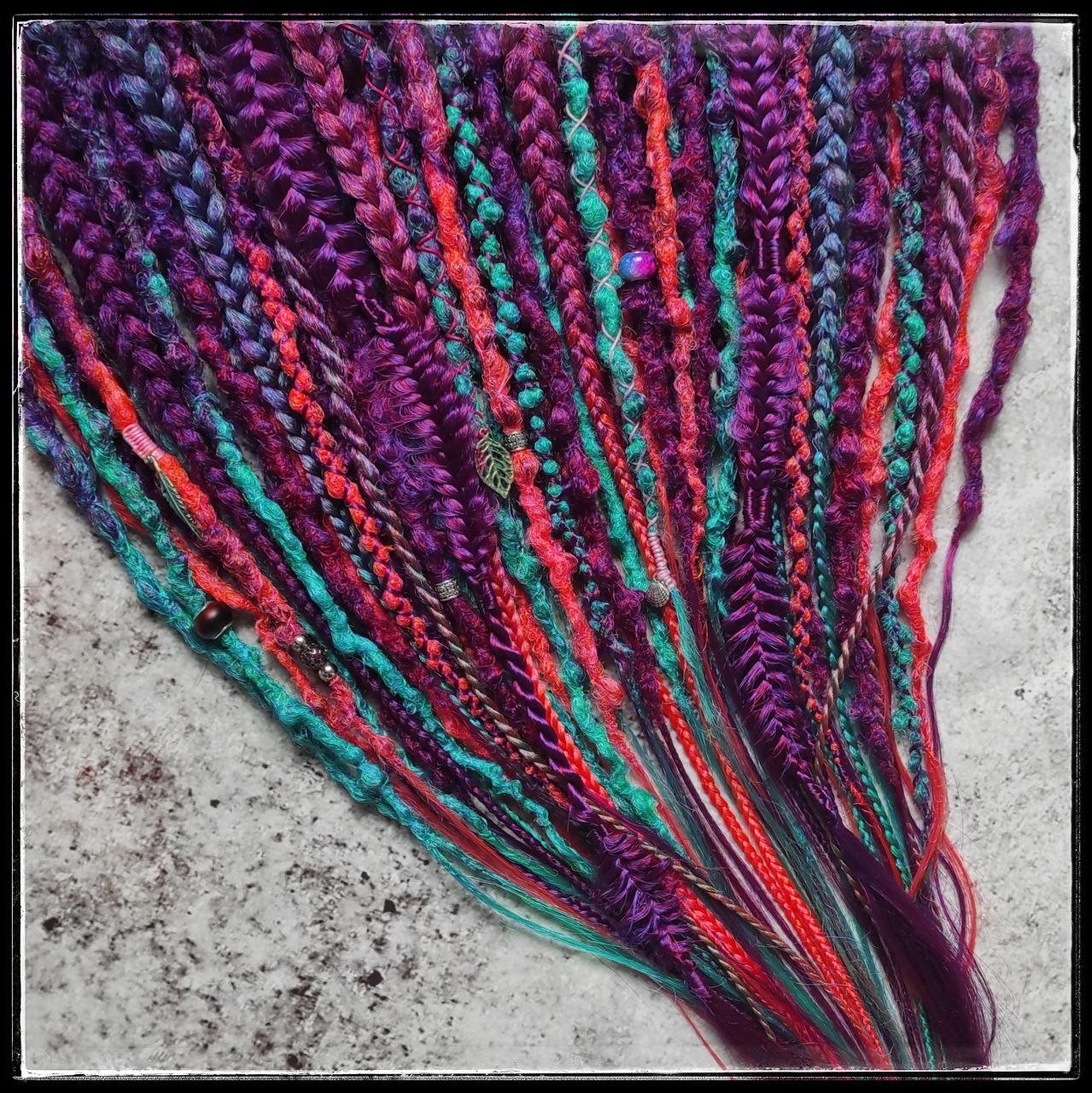 Synthetic dreads with braids featuring a striking ombre effect transitioning from purple to green and orange