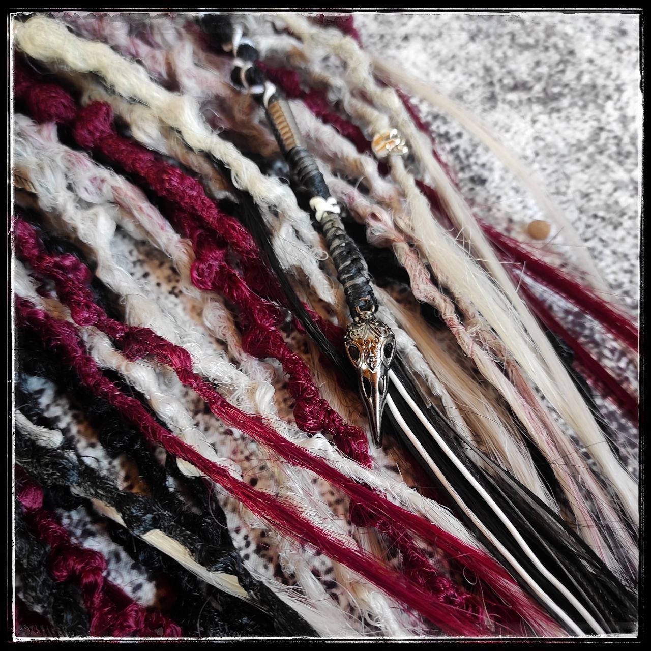 Solid black synthetic dreads transitioning into a red and grey ombre, available in a set of 30 double-ended dreads