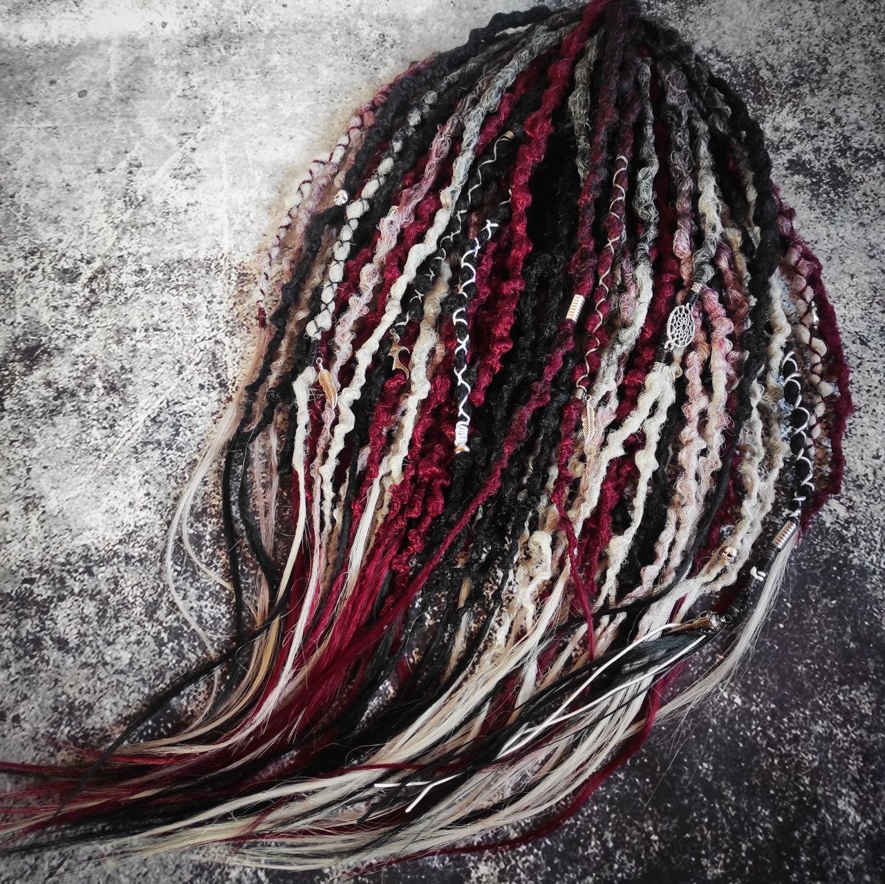 Solid black synthetic dreads transitioning into a red and grey ombre, available in a set of 30 double-ended dreads