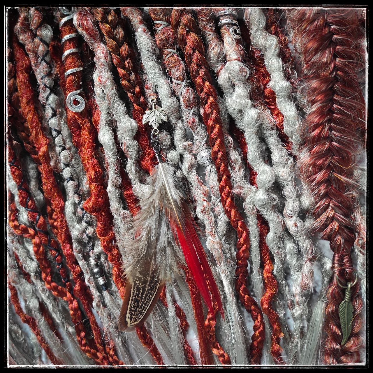 Synthetic dreads with an ombre transition from red auburn to gray, complemented by braids.