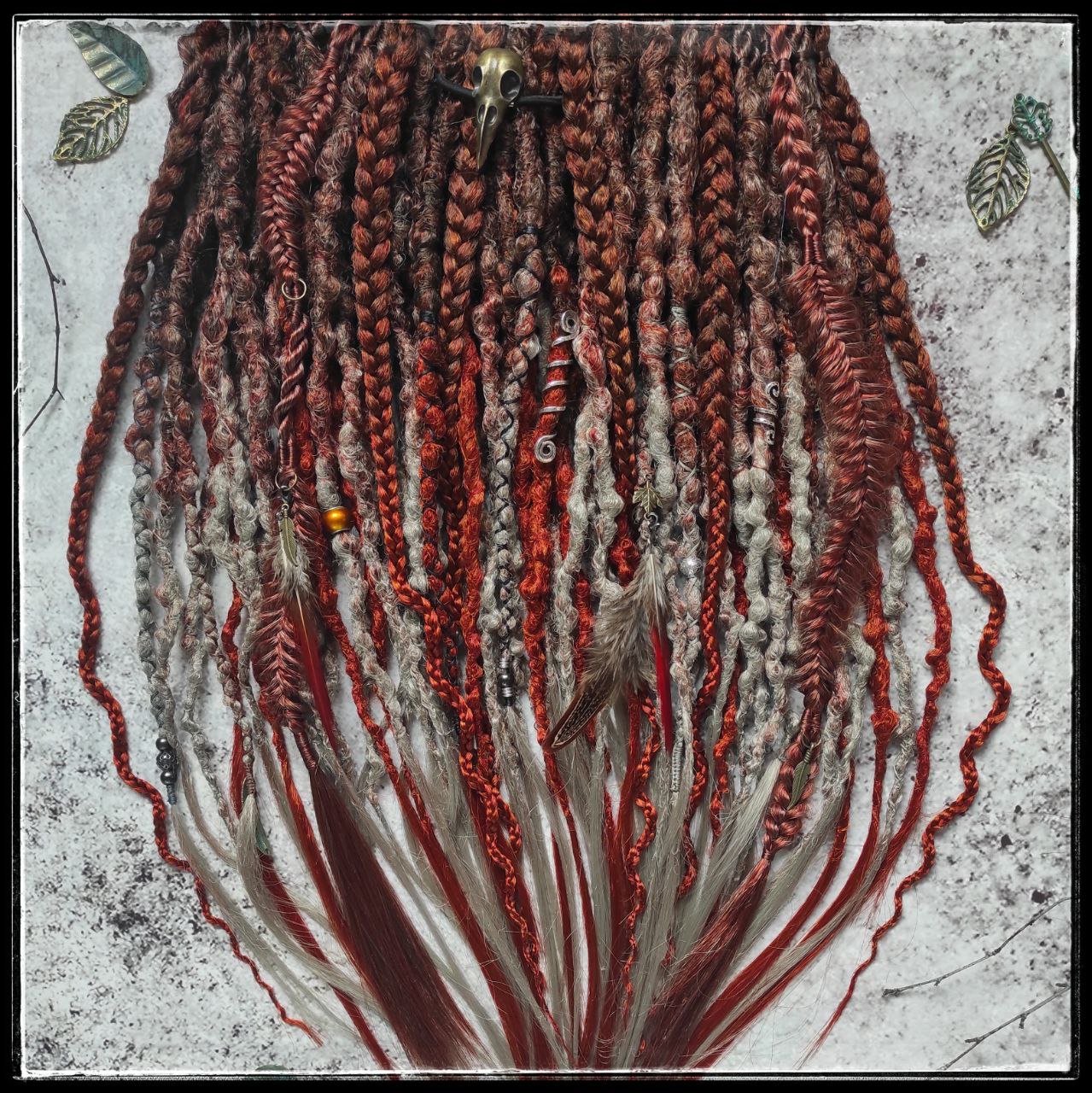 Synthetic dreads with an ombre transition from red auburn to gray, complemented by braids.