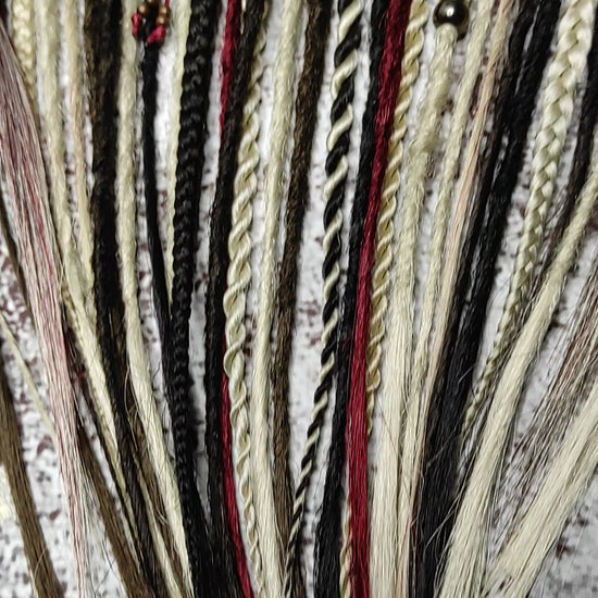 video of blond brown and red crochet dreadlocks with braids and witchy decorations