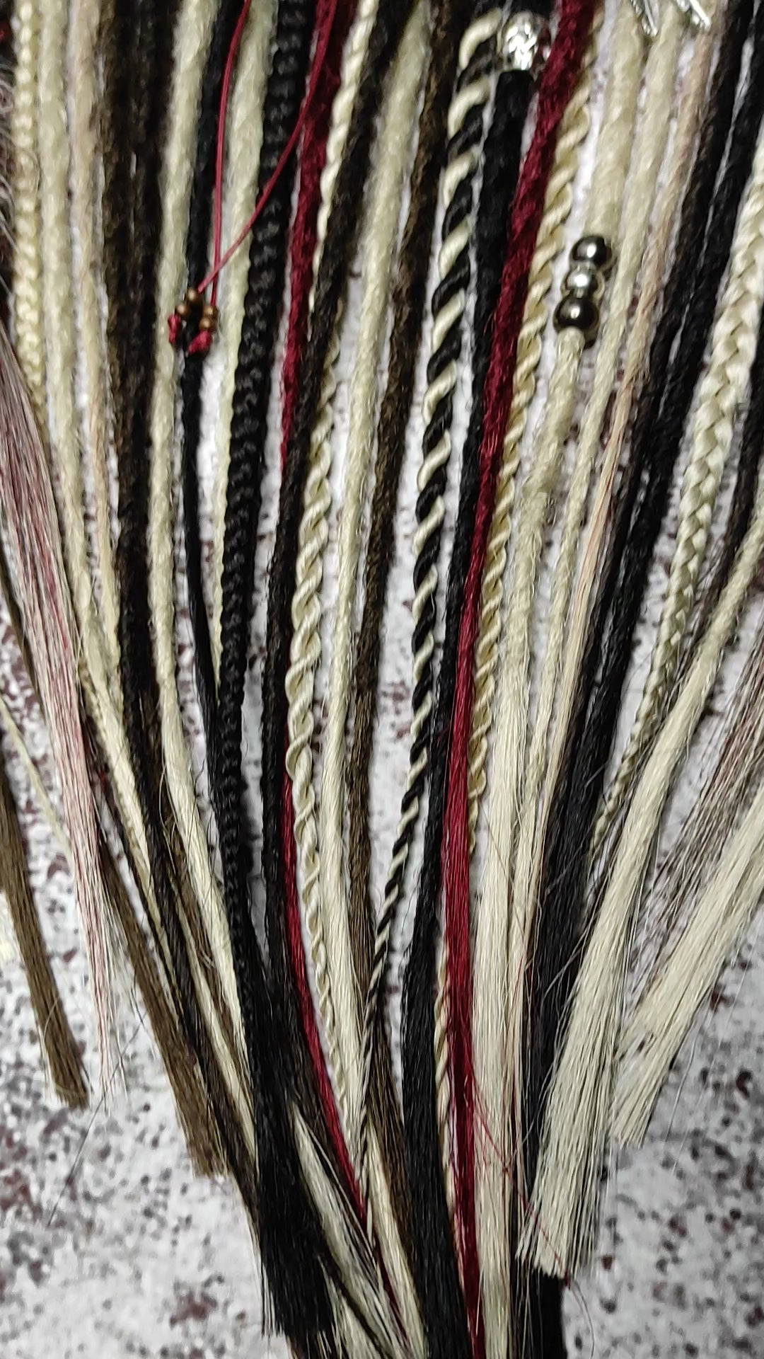 video of blond brown and red crochet dreadlocks with braids and witchy decorations