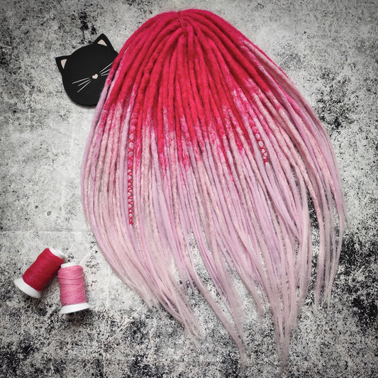 Synthetic double-ended dreads with a pink ombre effect