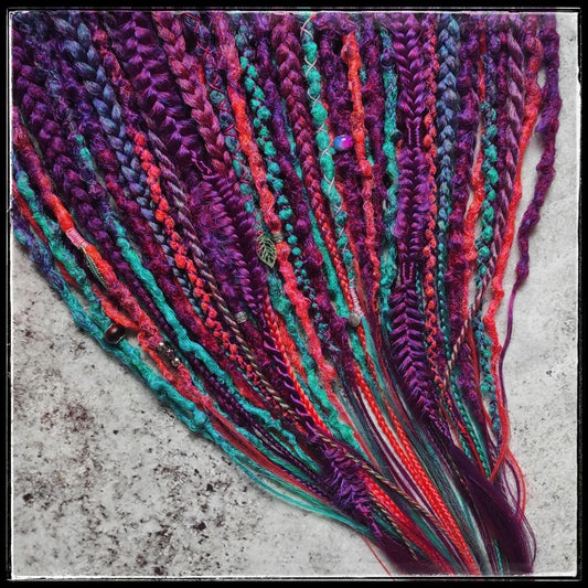 Synthetic dreads with braids featuring a striking ombre effect transitioning from purple to green and orange