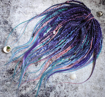 Purple synthetic dreads featuring brown-to-pink, turquoise, and blue ombre extensions, along with braids