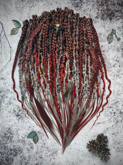 Synthetic dreads with an ombre transition from red auburn to gray, complemented by braids.
