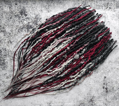 Synthetic dreads transitioning from solid black to red and grey ombre.